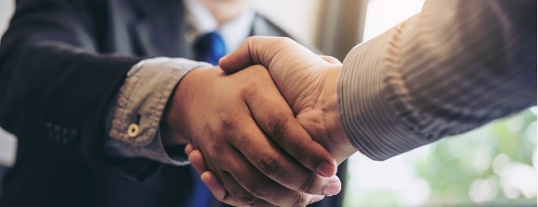 two-business-men-shaking-hands-during-a-meeting-to-sign-agreement-and-picture-id886031704