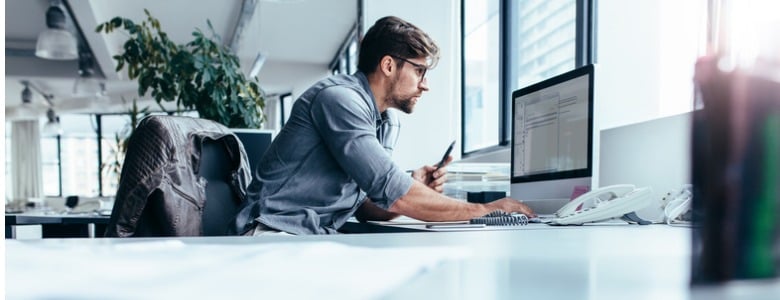 young-businessman-in-office-working-on-computer-picture-id872006502