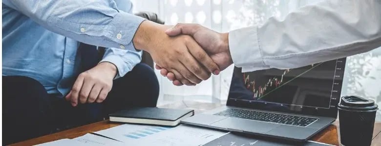 business shaking hands M&A transaction